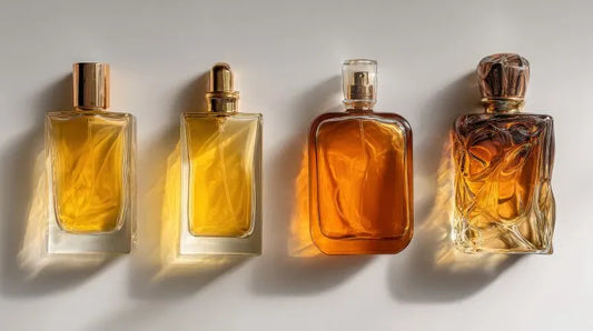 An elegant display of four perfume gift bottles arranged in a row, showcasing luxury fragrances in amber-colored glass, ideal for high-end gift sets