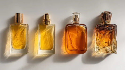 An elegant display of four perfume gift bottles arranged in a row, showcasing luxury fragrances in amber-colored glass, ideal for high-end gift sets